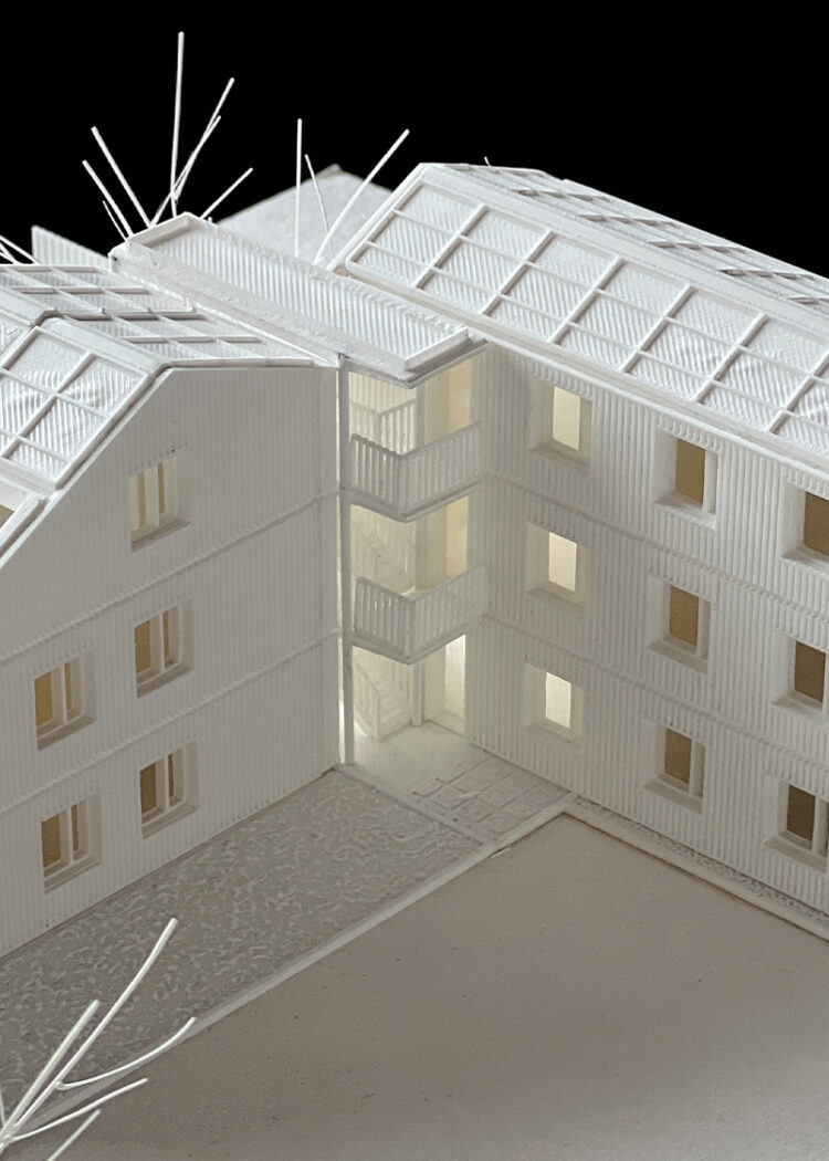 White architectural model of East Building showing multi-story structure with regular window pattern and surrounding landscaping elements"
