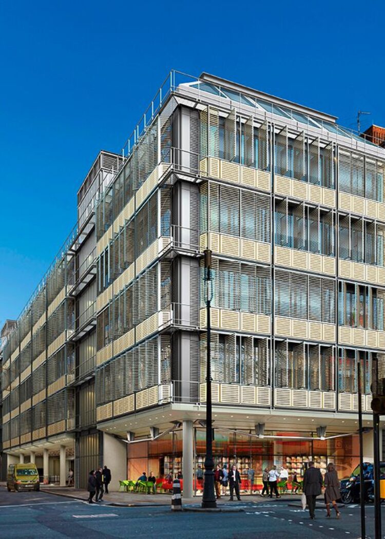 Modern glass and metal clad building exterior showing Grafton Way Building for University College London Hospitals with pedestrians on street levelf